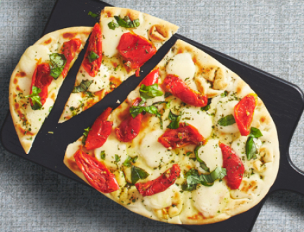 A picture of pizza served on a black plate